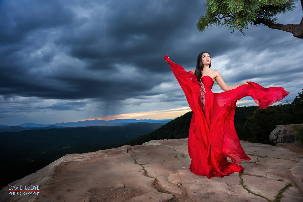 woman standing on edge of cliff outside wearing red dress, glamour shot, glamour photography, 