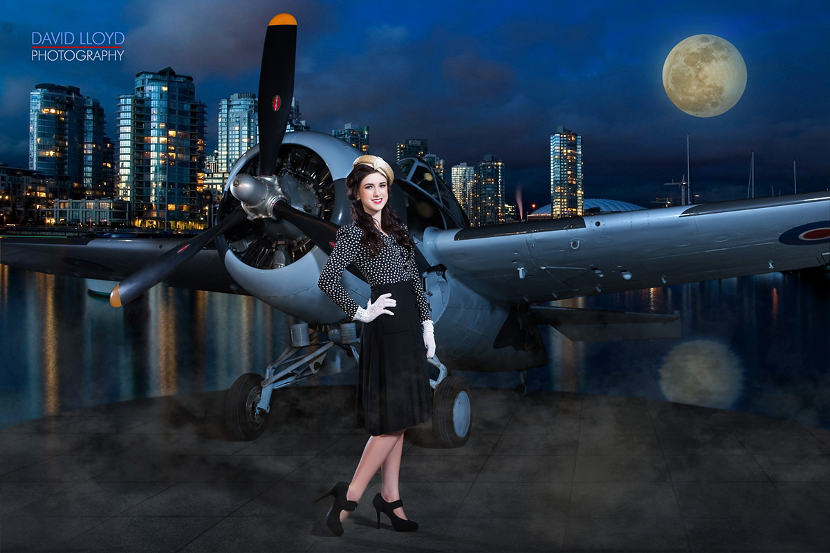 woman wearing dark skirt and spotted top with golden hat standing outside with military plane behind her and big city skyline against body of water and moon in background, fashion photography, model professional portraits, portraits in atlanta, head shots in atlanta
