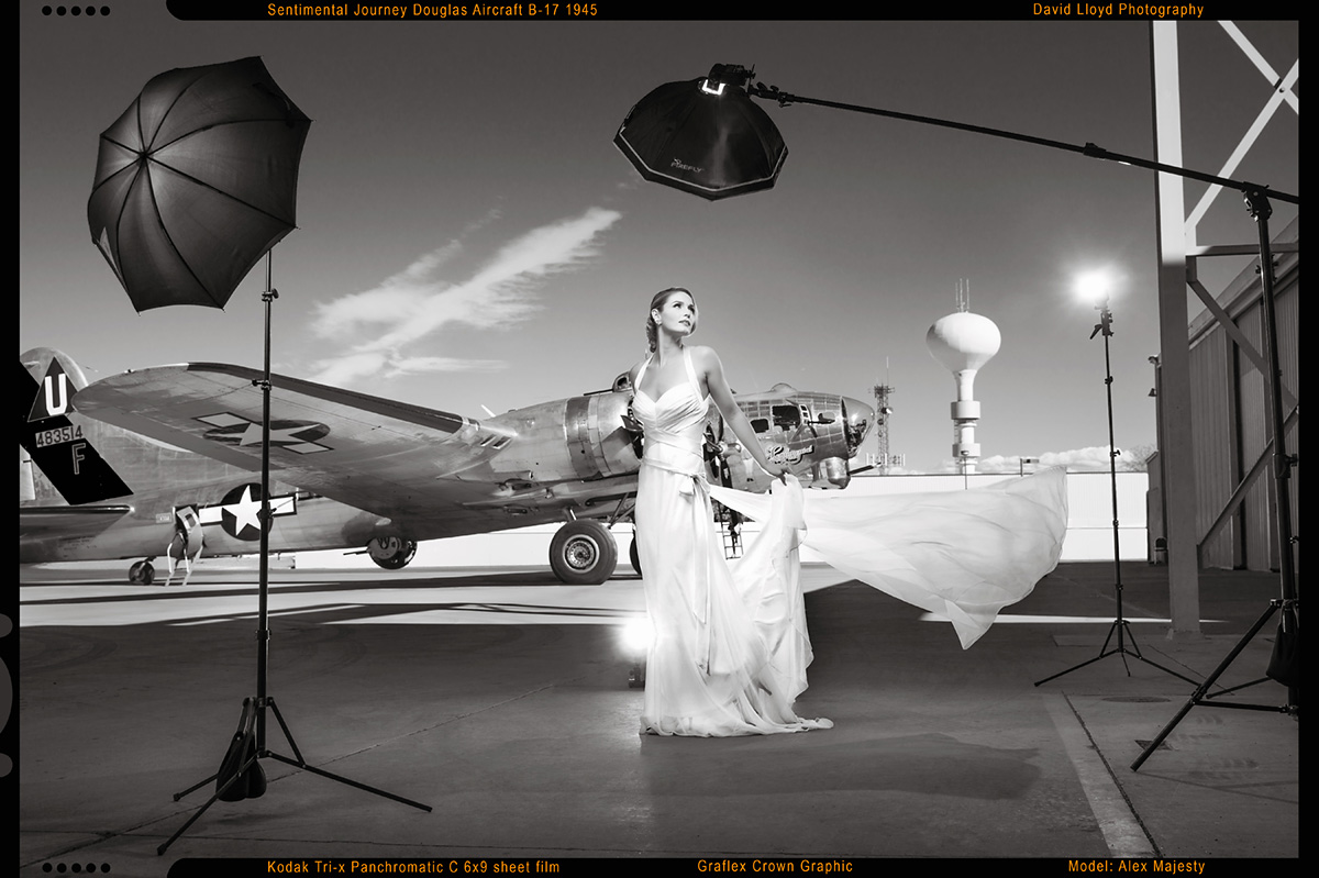 woman in white dress standing in front of studio lights with old school military plane in background, glamour photography, model photography, photography classes 