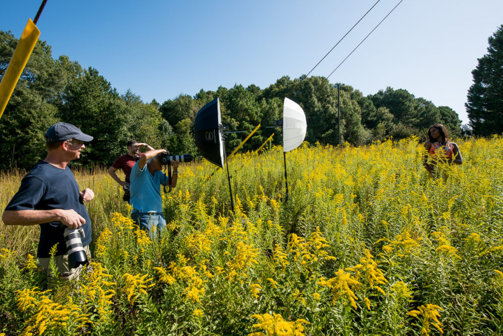 Photographers and Rick Ferro take photos of model in sunflower field, model photography in nature, portrait shoot, model poses, photography pose, photography class
