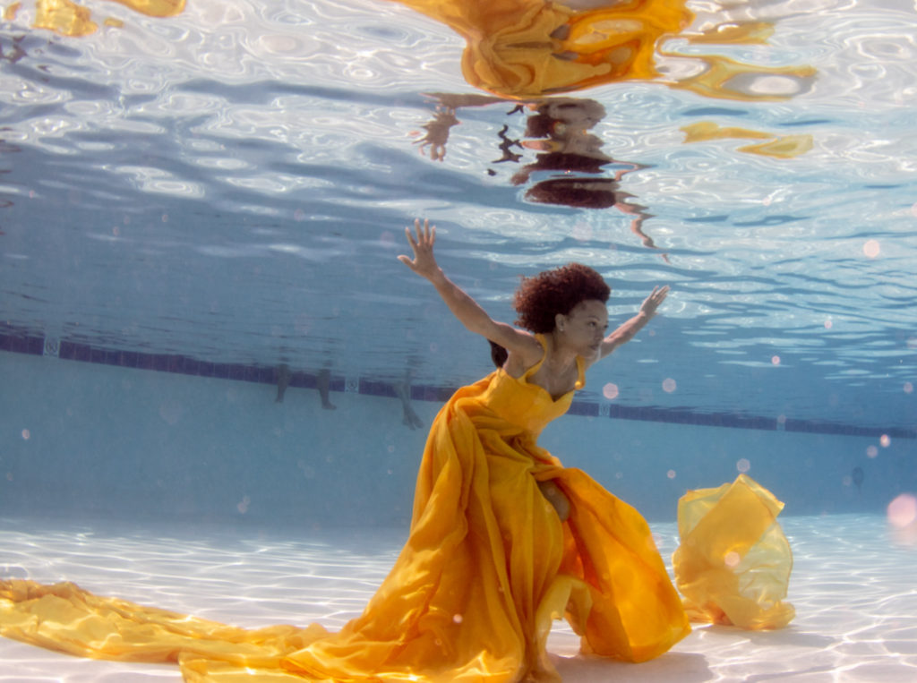 model in yellow dress underwater